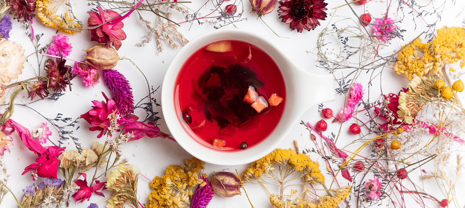 Blüten vertreut in der Mitte eine Tasse Tee